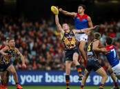 Melbourne have kept top spot on the AFL ladder after overcoming a gritty Adelaide in a 29-point win.