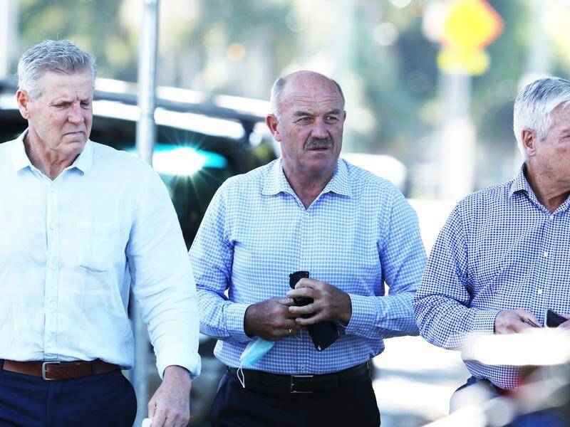 Wally Lewis (c) was among mourners at Tommy Raudonikis' funeral on the Gold Coast.