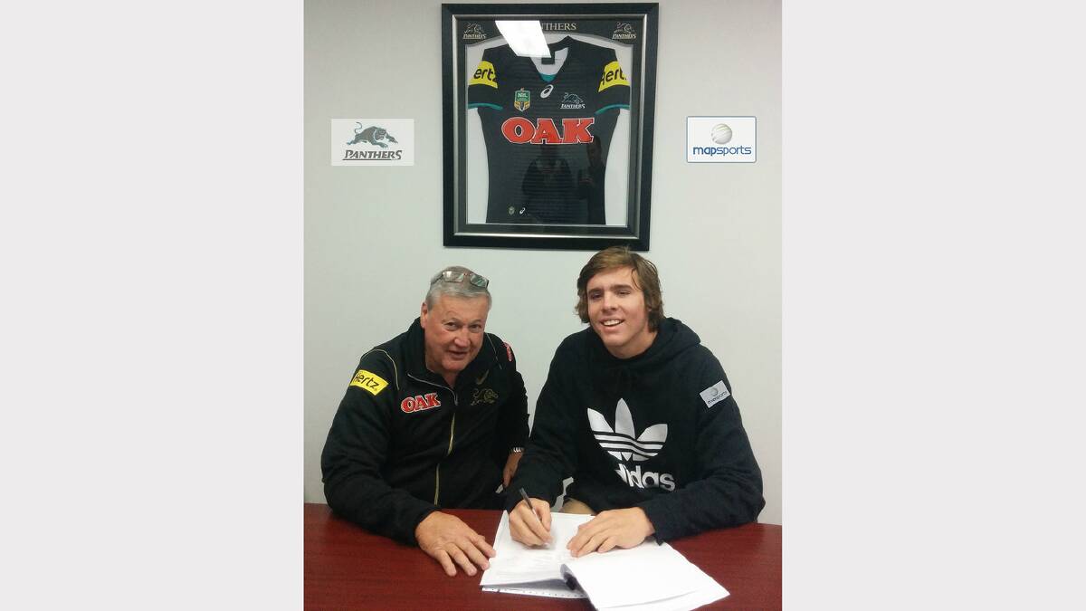 Penrith Panthers recruitment manager Jim Jones and Parkes’ Billy Burns signing his contract. sub
