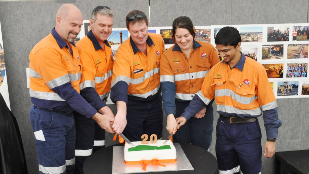 Rob Cunningham, Andrew Hubbard, Kirk McGinnes, Esther Bruce and Sanjeewa Senanayake cut the birthday cake to celebrate 20 years of operation by Northparkes Mines on Friday.
