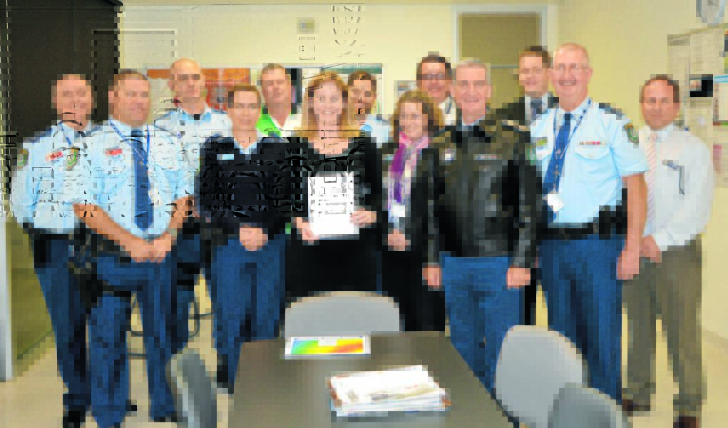 A delighted Senior Constable Ashlyn Johansson with her letter of congratulations, with proud fellow officers from Parkes Police Station at the presentation - from left, Inspector Nicholas Weyland, Inspector David Cooper, Sergeant Adrian Matthews, Senior Constable Sandra Barton, Sergeant Peter Gibson, Senior Constable Ashlyn Johansson, Sergeant Ben Dawson, Detective Senior Constable Paula Farmer, Detective Senior Constable Anthony Durkin, Commissioner Andrew Scipione, Detective Senior Constable Dale Holmes, Superintendent Chris Taylor, and Detective Sergeant Steve Howard. Photo: Roel ten Cate.