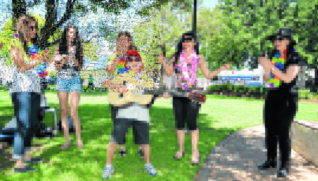 He is pictured during an impromptu performance in Cooke Park this morning with family members Evelyn Mannah, Saide Mannah, Helen Karam  and Clarette Mannah.    Photo: Bill  Jayet  0116ElvisElijah
