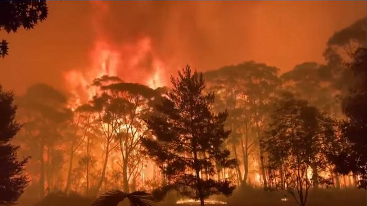 BLAZE: Flames were caught on video roaring above the height of trees at Mount Tomah on Sunday. Photo: TERREY HILL RURAL FIRE BRIGADE