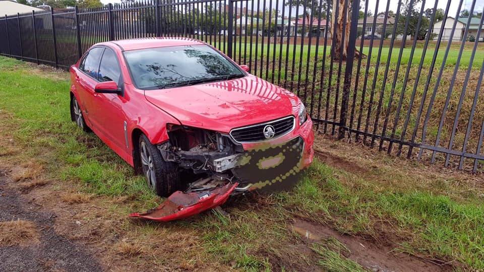 CRASH SITE: A driver lost control of his vehicle and crashed through the fence at Parkes High School. Photos: NSW POLICE