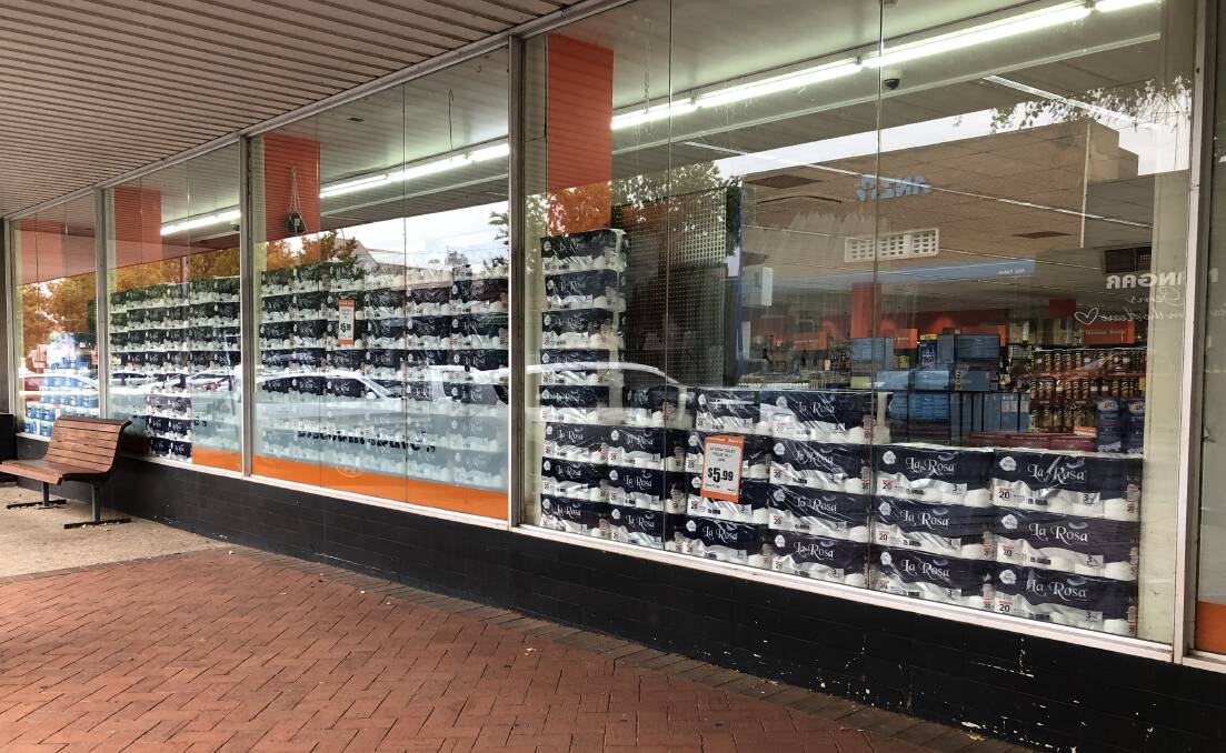 DISCOUNT DAVES: Discount Daves in Parkes stacked their available toilet rolls in its shopfront window on Wednesday.