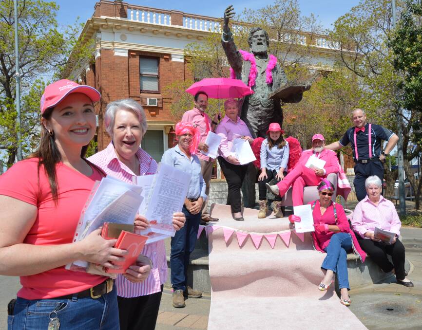 TICKLED PINK: Pink Up Parkes supporters, from left, Marg Applebee, Jenny Breaden, Geoff Rice, Bill Thomas, Carolyn Rice OAM, Clara Rice (9), Mayor Ken Keith OAM, Beth Thomas, Ben Terry (Terry Bros Parkes) and Lorraine Parker on the eve of the Pink Up Your Town month-long fundraiser. Photo: Christine Little