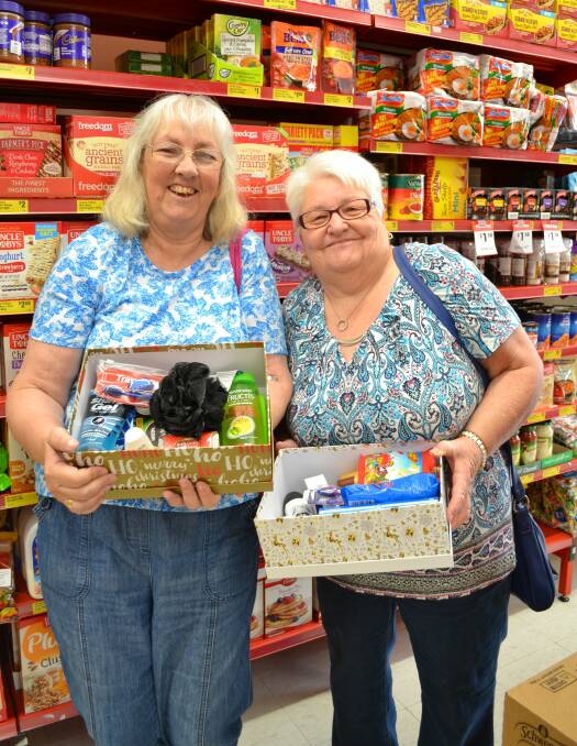 Treasurer, Kerry Buerckner and Vice-President, Shirley Russell are pictured with some of the goodies they have collected for the Care Packages. 