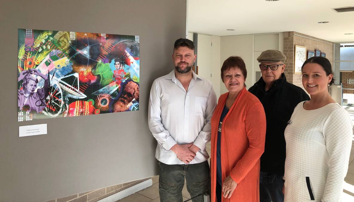 DIFFERENT PERSPECTIVE: Sean James Cassidy, Kerrie Peden, James Cassidy and Parkes Shire Council's Natalie Williams with one of Sean's works from his most recent exhibition at the Parkes Cultural Centre. Photo: Submitted