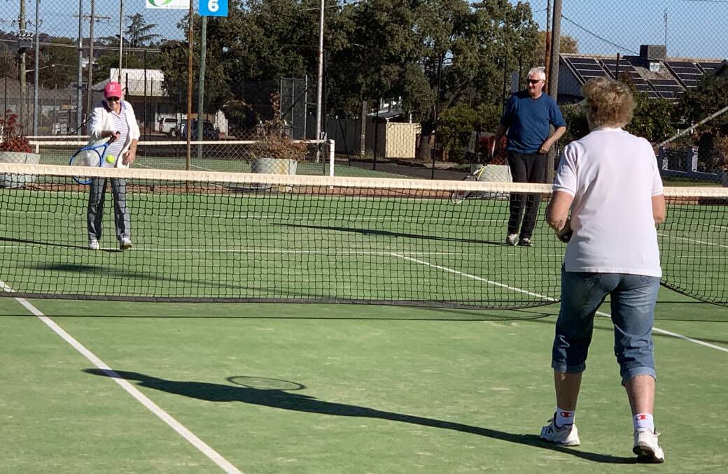 HAVING A HIT: Pauline Nicholson, Michael Henry and Helen Jolly (back to camera) enjoying their Saturday social tennis. Photo: Submitted