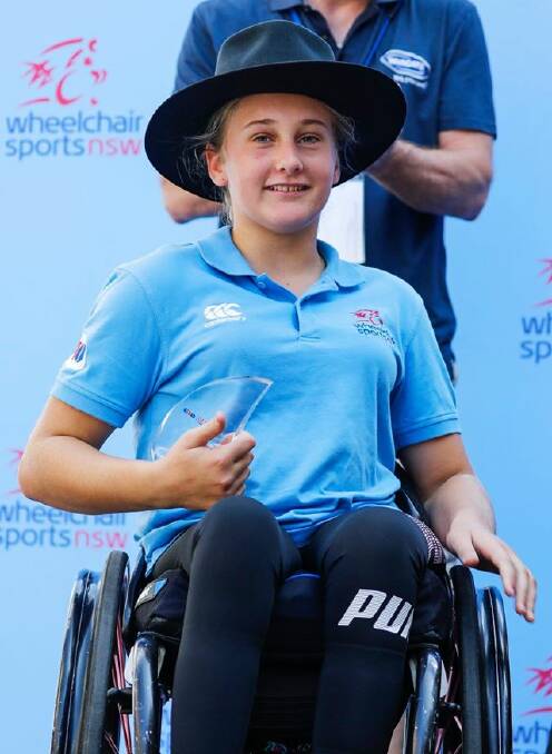 PRESENTATION: Victoria Simpson with her award after winning the junior section of the GIO Oz Day 10K on Australia Day in Sydney. Photo: Wheelchair Sports NSW