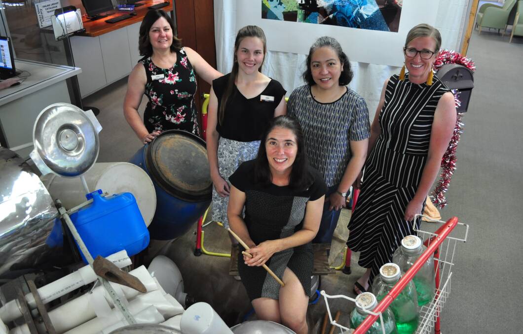 LAST DAYS: Shellie Buckle with her colleagues Sandie Ward, Claire Cassell, Anna Sinaga and Sally Chapman around the Junkyard Drum Kit, the feature of the library's latest exhibition Art Forged In Miscellany.