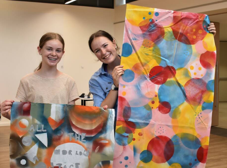 FINAL PRODUCT: Sophie McQuie and Kate Rice had fun taking part in the Banners from Recycled Materials workshop during the Arts Revival Festival in December.