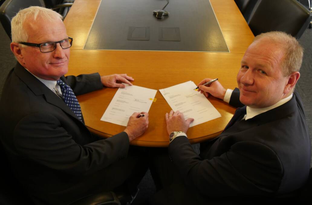 SIGNING: ARTC CEO John Fullerton and ARTC General Counsel and Company Secretary Gavin Carney sign the $300 million construction contract for the first section of Inland Rail between Parkes and Narromine. Photo: Submitted