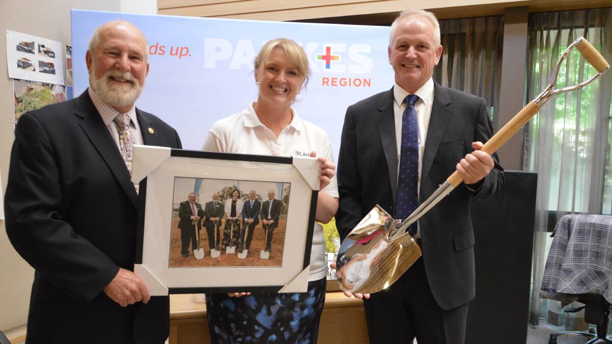 PRESENTATION: Inland Rail staff member Cindy Nutley (centre) presented Cr Ken Keith OAM and general manager Kent Boyd two engraved Inland Rail shovels and a photograph from the December 13 sod turning ceremony. Photo: Christine Little