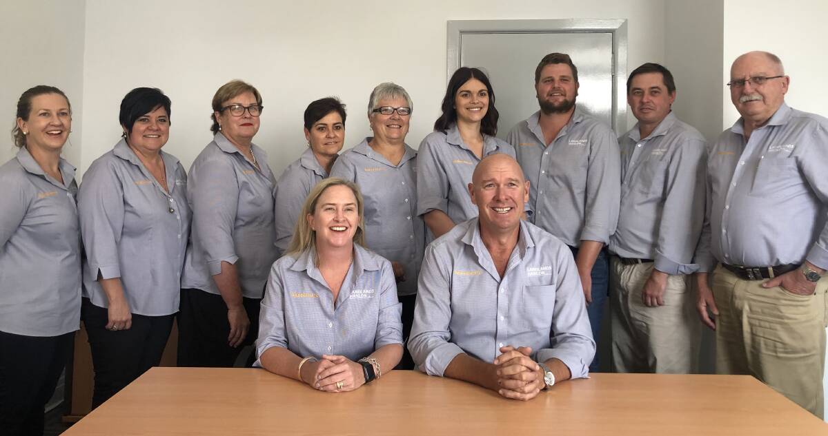 LUCKY NUMBER THREE: The thrilled team at Raine & Horne and Langlands Hanlon Parkes - back, Susan DeLacy, Kelly Spedding, Marg Porter, Sandra Tildsley, Gaye Lees, Kayla Ward, Cooper Byrnes, Greg Miller and David Hughes; front, Renee and Geoff Rice. Photo: Submitted