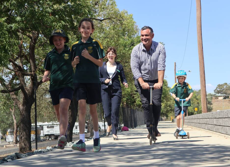 ON THE MOVE: Holy Family Primary School students Charlotte Baird, Leah Van Der Mewre and Aiden Van Der Mewre with Nationals candidate for Orange Kate Hazelton and NSW Deputy Premier John Barilaro. Photo: Submitted