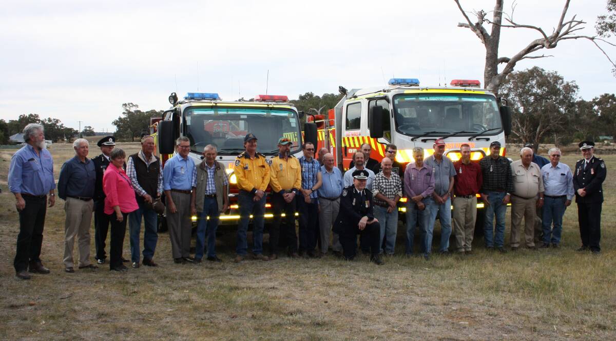 CEREMONY: Sixty five long service medals were presented to East Parkes Brigade volunteers and two new fire tankers were officially handed over. Photo: Submitted