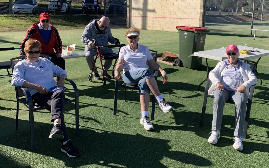 SOCIALISING: Back, Bob Green and Fred Swetland, front, Irene Trueber, Helen Jolly and Pauline Nicholson resting between matches during Saturday's social tennis at 1pm. Photo: Submitted