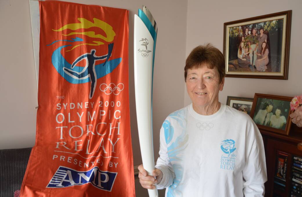ONCE IN A LIFETIME: Maureen Massey was one of the Sydney 2000 Olympic Torch bearers from Parkes 20 years ago and she still has her torch at home to remember the monumental occasion, along with one of the special flags that hung in Clarinda Street at the time. Photo: Christine Little