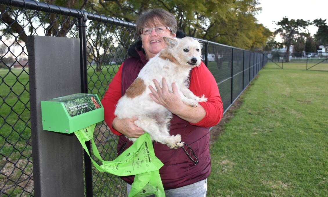 RESPONSIBLE: Shelley Bishop with Brucie utilising the dog waste bags that are available at the Kelly Reserve dog park. Photo: Jenny Kingham