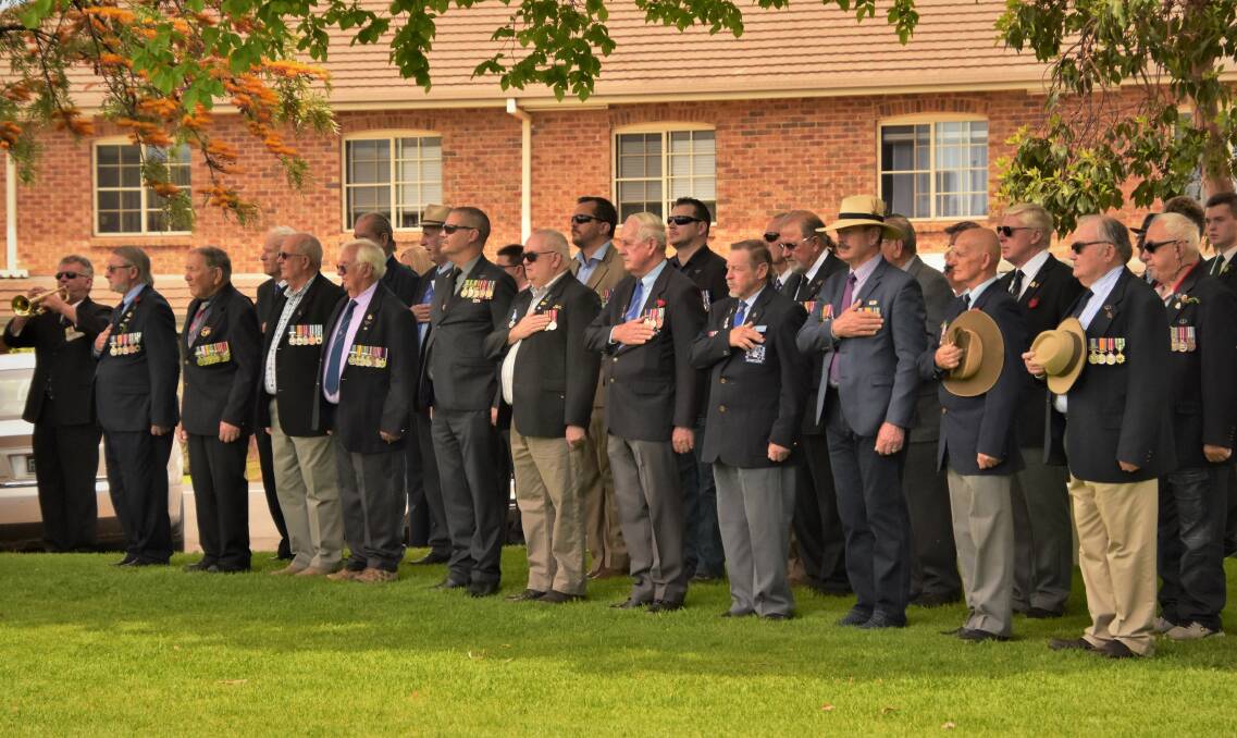 2018: Parkes and visiting servicemen and women pause during the Last Post at the 2018 Remembrance Day ceremony in Cooke Park.