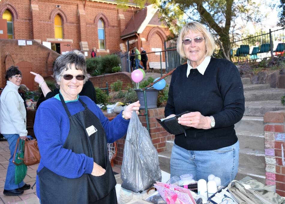 SHOPPING: Carol Corbett serves Heather Veal at the Trash and Treasure Stall during last year's spring market day. Photo: Jenny Kingham