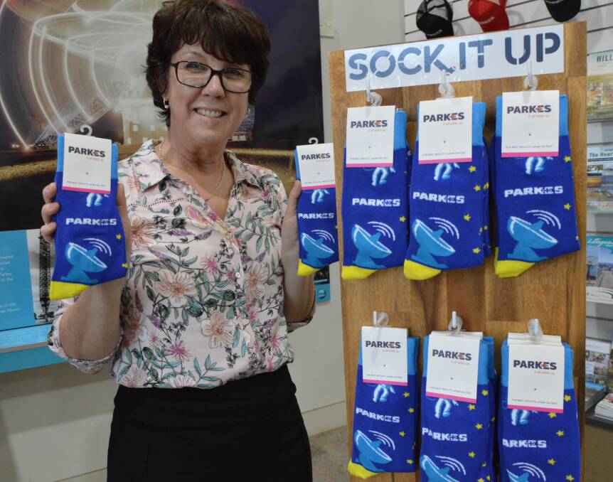 SOCK IT UP: Parkes Visitor Centre team leader Lisa Moon with the new range of socks featuring the Dish, available at the centre.