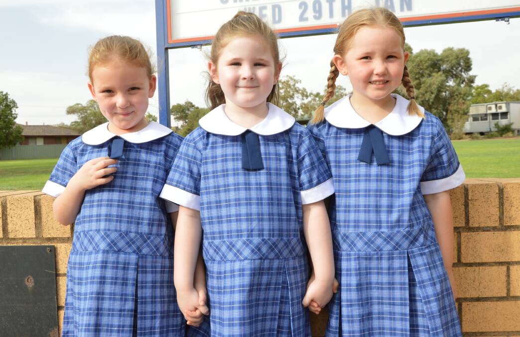 OFF TO SCHOOL WE GO: Five-year-olds Sophie Doughty and Tatum Lawler, and four-year-old Olivia Doering are among the 45 kindy students starting at Parkes Public School on Monday. Photo: Christine Little