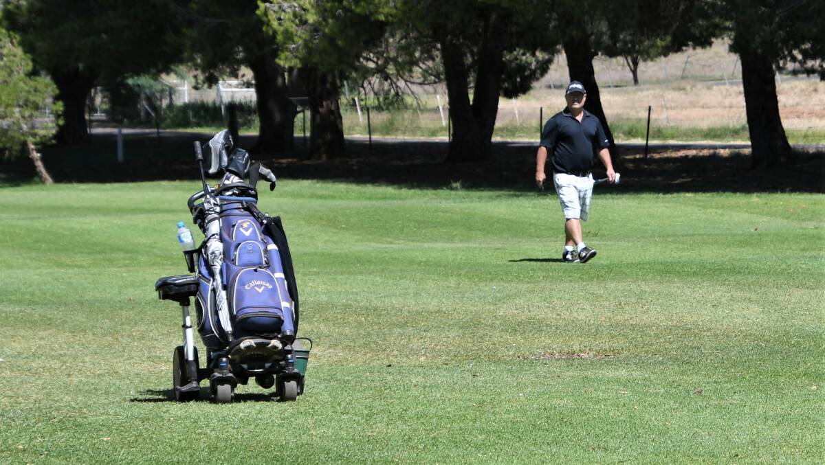 STILL OPEN: After reconsideration, the NSW Office of Sport has advised that golf is considered an activity that can continue to be played in line with Public Health Orders relating to public gathering limits, social distancing, and the elderly. Pictured is Mark Kelly with his remote control motorised golf buggy, playing a round on March 21. Photo: Jenny Kingham