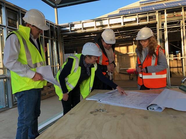 NOT LONG NOW: Parkes Shire Council Corporate Services Director Les Finn, Parkes Library manager Kerryn Jones, CUC Parkes Deputy Chair Jodi McIntyre and CUC Parkes Chair Tracie Robertson check out the plans of the Country Universities Centre in Parkes. Photo: Submitted