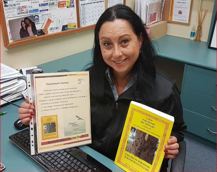 PACKAGE DELIVERED: Amanda Corcoran from Neighbourhood Central with a Wiradjuri language package. Photo: Submitted.