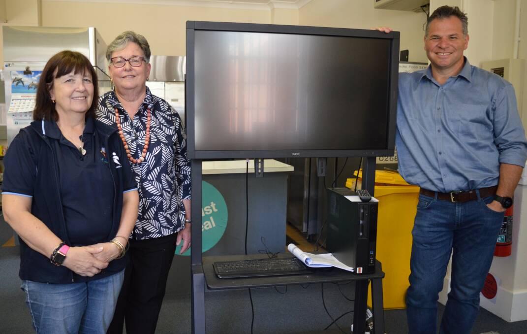 ESSENTIAL: Parkes Shire Food Service manager Gillian Kinsela, the board's chairperson Carolyn Rice OAM and State Member for Orange Phil Donato with the new equipment. Photo: Christine Little