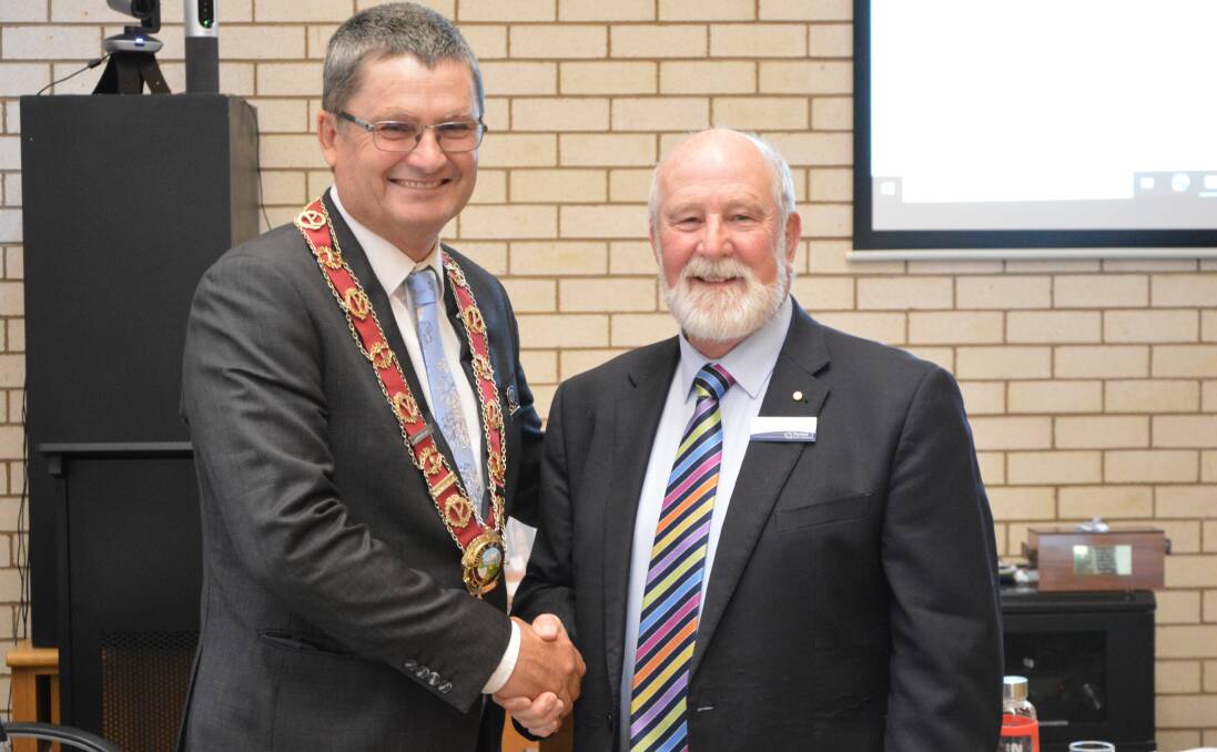 End of an era as outgoing mayor of 17 years Ken Keith OAM handed the baton - in the form of the mayoral chains - to new mayor Neil Westcott on September 19. Photo by Christine Little