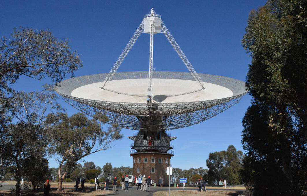 MAY 2018: Onlookers watched as the former 15-year old receiver was lowered from the peak of the Parkes Radio Telescope on May 15, 2018 and the $2.5 million ultra-wide band receiver lifted into its place. Photo: Christine Little