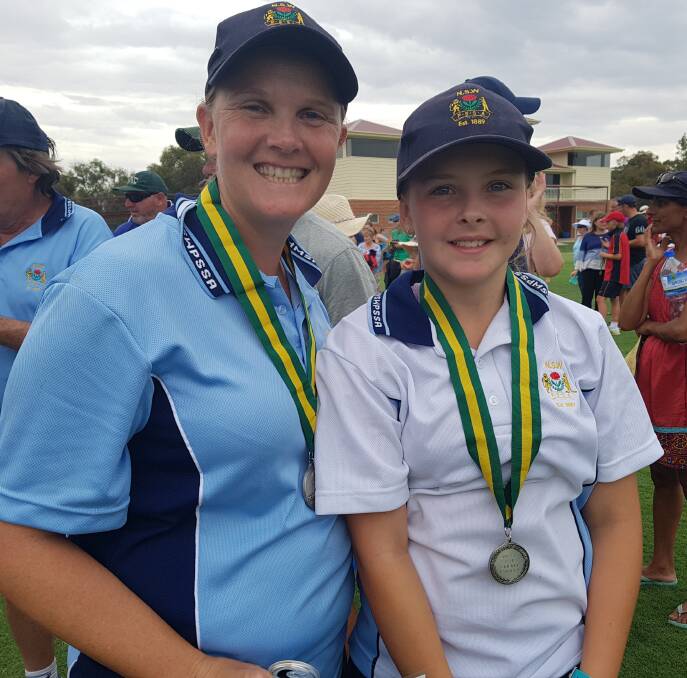 IN THE RUNNING: Parkes Junior Cricketer Maddy Spence (right) and NSW PSSA Girls Firsts Cricket team manager Belinda Allard with the silver medals they received at the National Cricket Carnival.