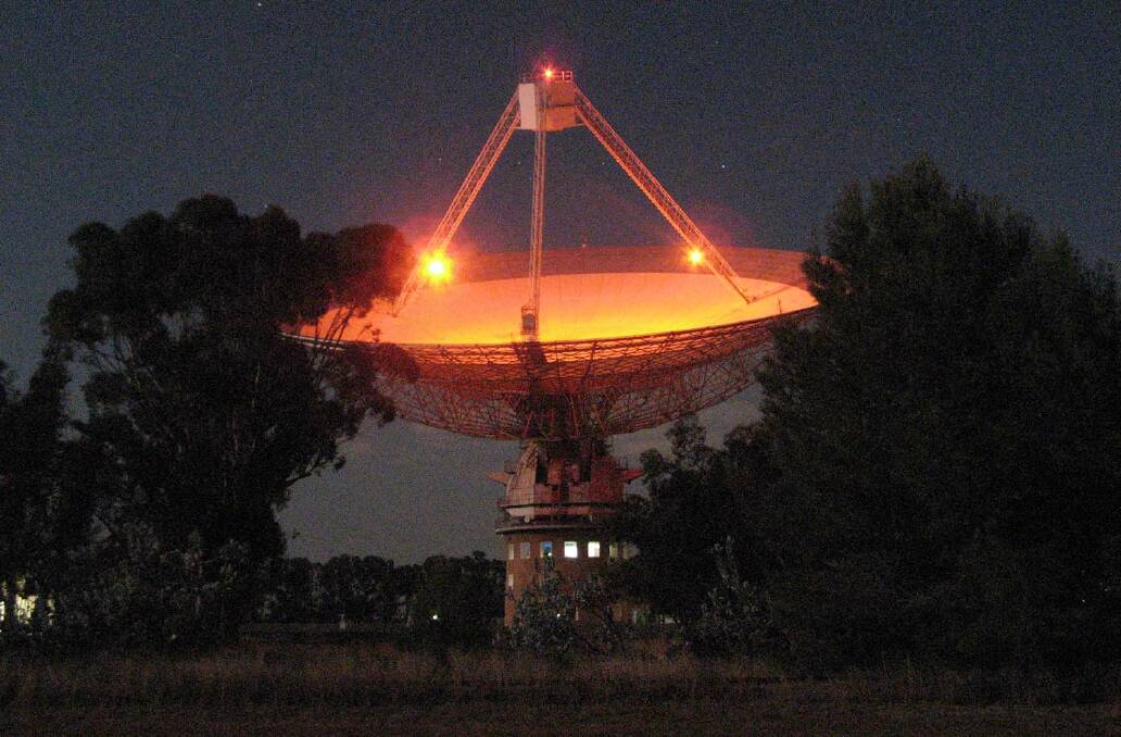 TEST RUN: Parkes Observatory site leader Mal Smith took this photo of the Dish lit up orange to test the lighting for Wednesday's WOW Day event. Photo: Mal Smith