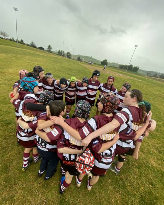 GO TEAM: Parkes' under 12s players come together for a pre-game huddle in the cold and wet conditions. Photos: Submitted