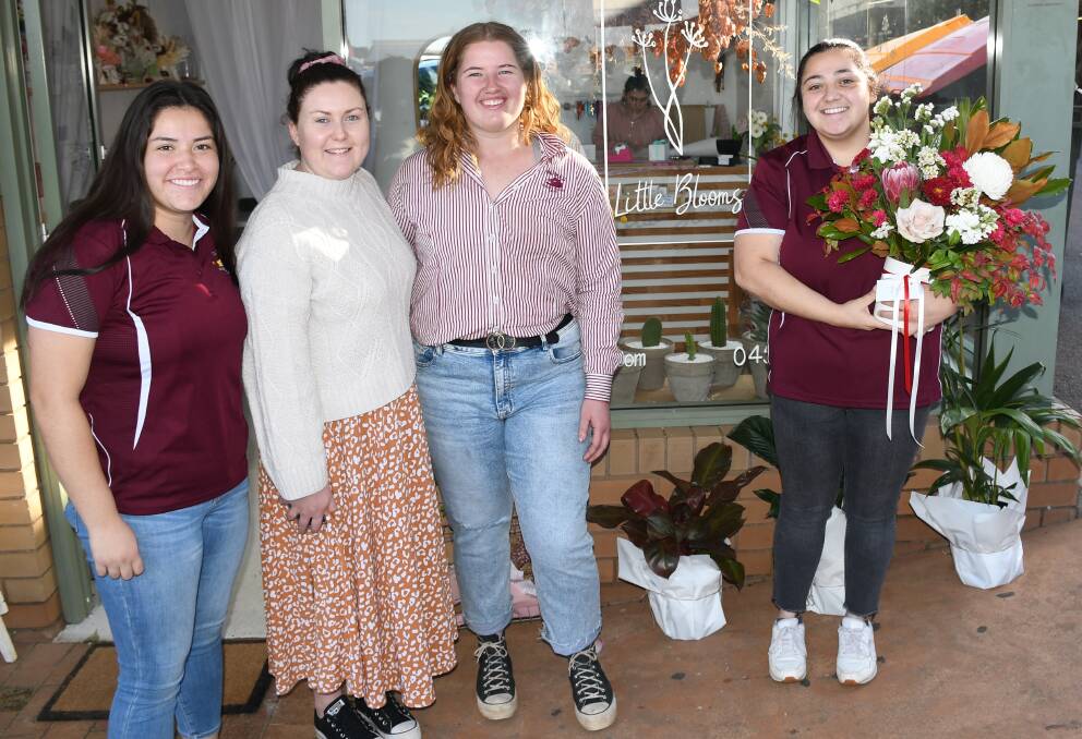 THANK YOU: Parkes Boars women Karsyn Blanco, Makeely Van Dyk and Sunshine Packer thank major sponsor Dimity Ross (second from left) from Little Blooms for her generous support. Photo: ALLAN RYAN