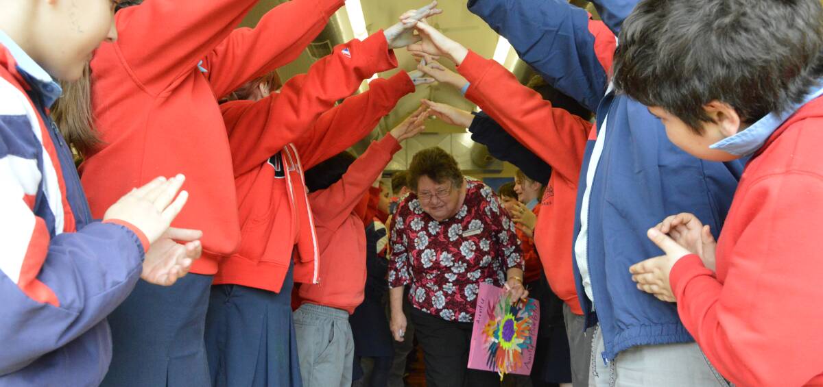 Middleton Public School students cheered and rose to form a tunnel with their arms for canteen supervisor Barbara Osbourne as she exited the school hall for the last time.