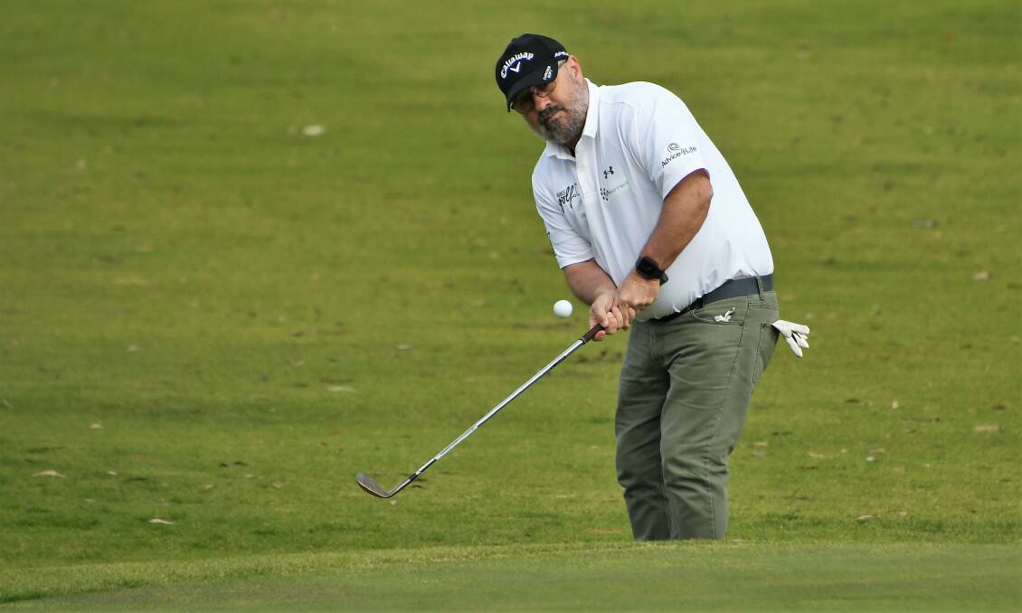 FOCUS: Mark Kelly chipped his ball onto the green during Saturday's games at the Parkes Golf Club. Photo: JENNY KINGHAM
