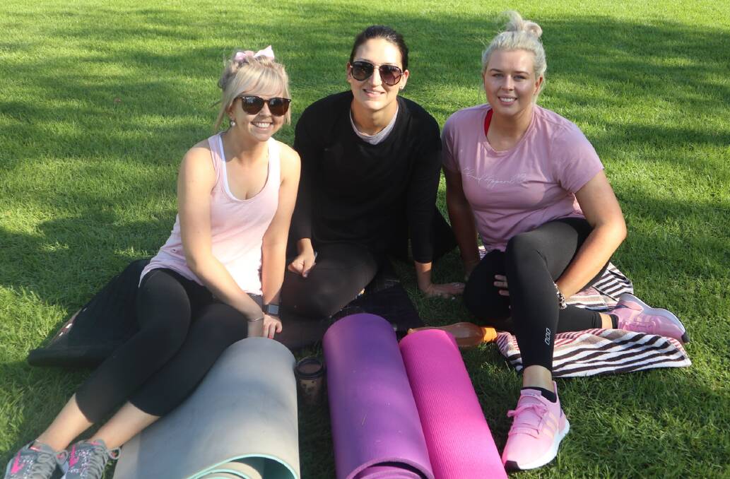ACTIVITIES IN THE PARK: Parkes women Cody Sense, Jess Galvin and Courtney Stone are ready to take part in some pilates and yoga in Cooke Park on Monday.