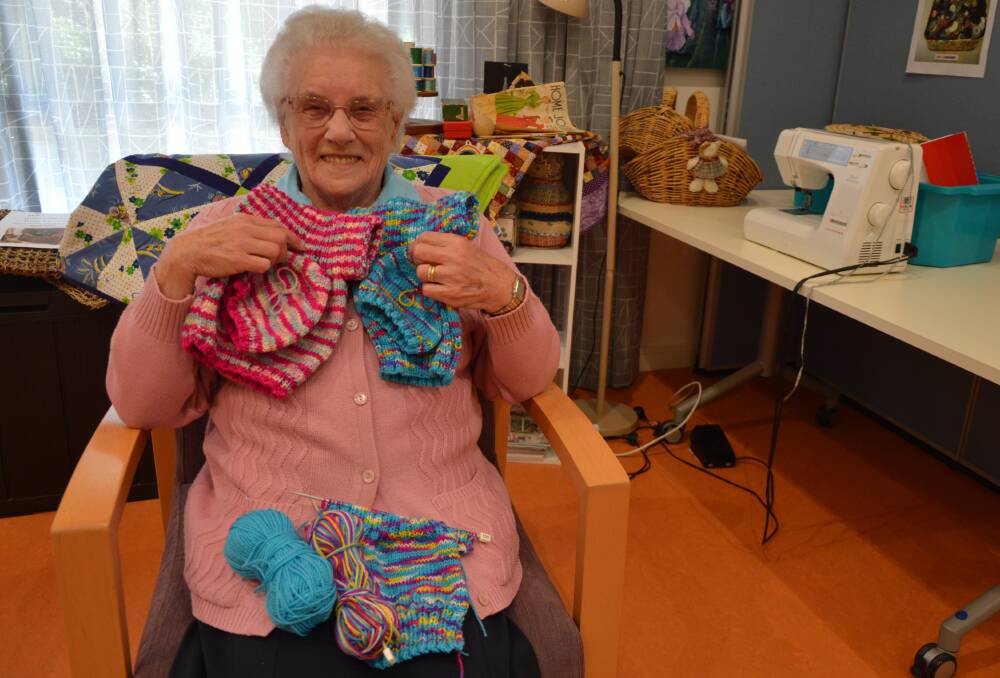 BUSY HANDS: Rene Pearson is a new resident to the Southern Cross Village and for the last 10 years has been knitting baby clothes and bonnets for babies in Africa. Photo: Christine Little