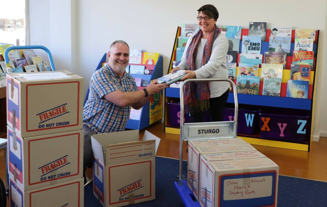 MOVING DAY: Library officers Dan Fredericks and Emma Brown have started packing boxes ahead of their move back to Bogan Street and into the newly renovated Parkes Library. Photo: Submitted