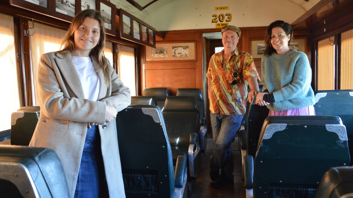Sponsorship and marketing officer Charlotte Lerpiniere, festivals producer Julien Poulson and festivals and events manager Rochelle Livingstone, aboard a carriage from the Silver City Comet that's on display at the Henry Parkes Museum. Picture by Christine Little