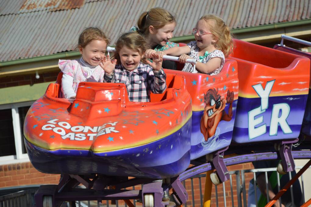 WHAT FUN: You couldn't wipe the smiles off these Parkes youngsters' faces while riding the Looney Coaster ride on Tuesday afternoon. Photo: Christine Little