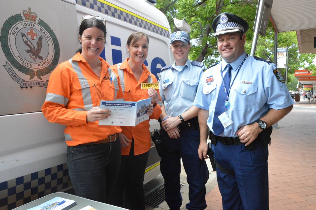 CHAT: INLink staff Amy Walker and Angela Corbett enjoyed a chat about security with Senior Constable Daniel Greef and Chief Inspector Dave Cooper in the main street.
