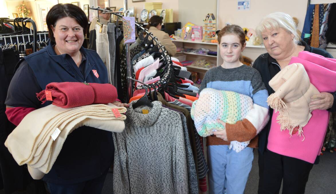 CAN YOU HELP: Major Sandra Walmsley, Molly Clohessy (11) and Joanne van Unen from The Salvation Army only have a few handfuls of blankets left at the Parkes store. Photo: CHRISTINE LITTLE
