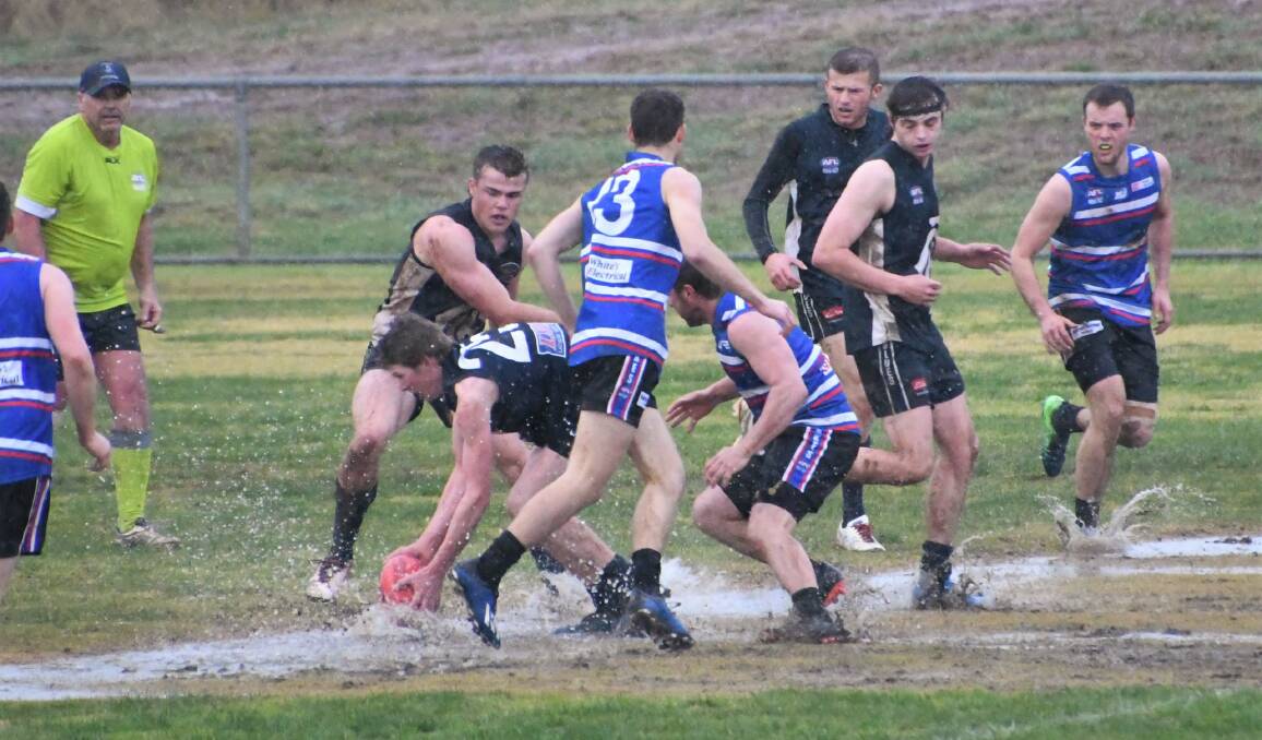 WET AND MUDDY: Just over 17mm of rain was recorded in Parkes this weekend, since 9am Friday, which made for some tough playing conditions for local sports, including the AFL game between Parkes Panthers and Cowra Blues at Northparkes Oval. Photo: Jenny Kingham