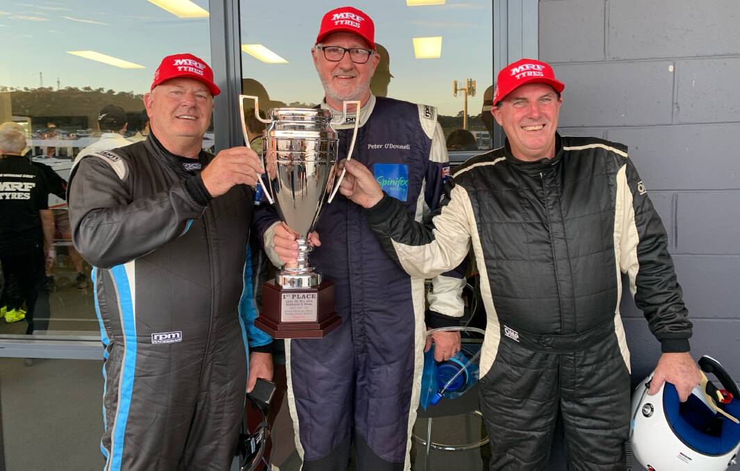 FIRST PLACE: Parkes businessman Peter O'Donnell (centre) and his team Garry Mennell and Peter Johnston with the Class B1 trophy after Sunday's win at the Bathurst 6 Hour. Photo: Submitted