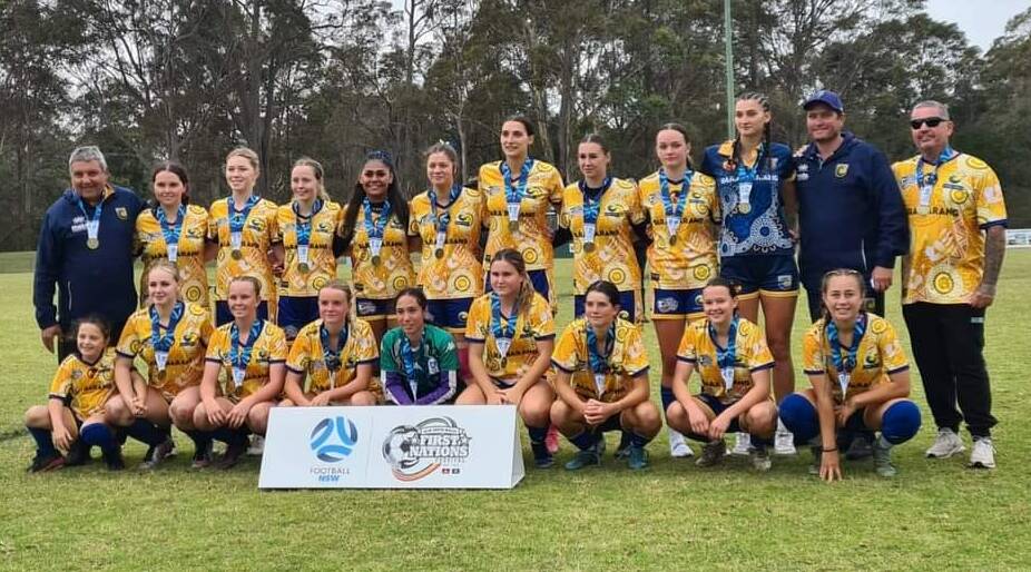 Makayla Sloane from Parkes (back, third from right) and her Central Coast Indji Girls Team with their gold medlas. Photo on Facebook